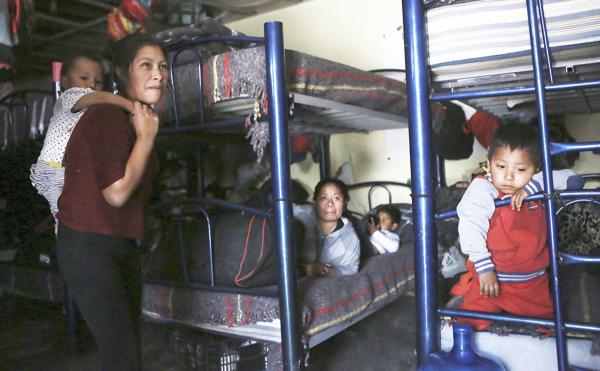 Migrants seeking asylum in the U.S. wait in a crowded shelter in Juarez, Mexico.