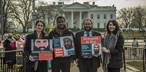 CCR lawyers and legal advocates holding images of GITMo clients